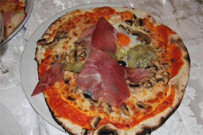 pizza with egg, artichokes, ham and mushrooms