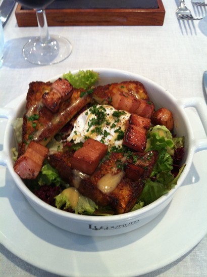 Lyon style salad served with a cake of pig’s ears