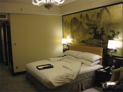 The bed with nice picture on the wall
